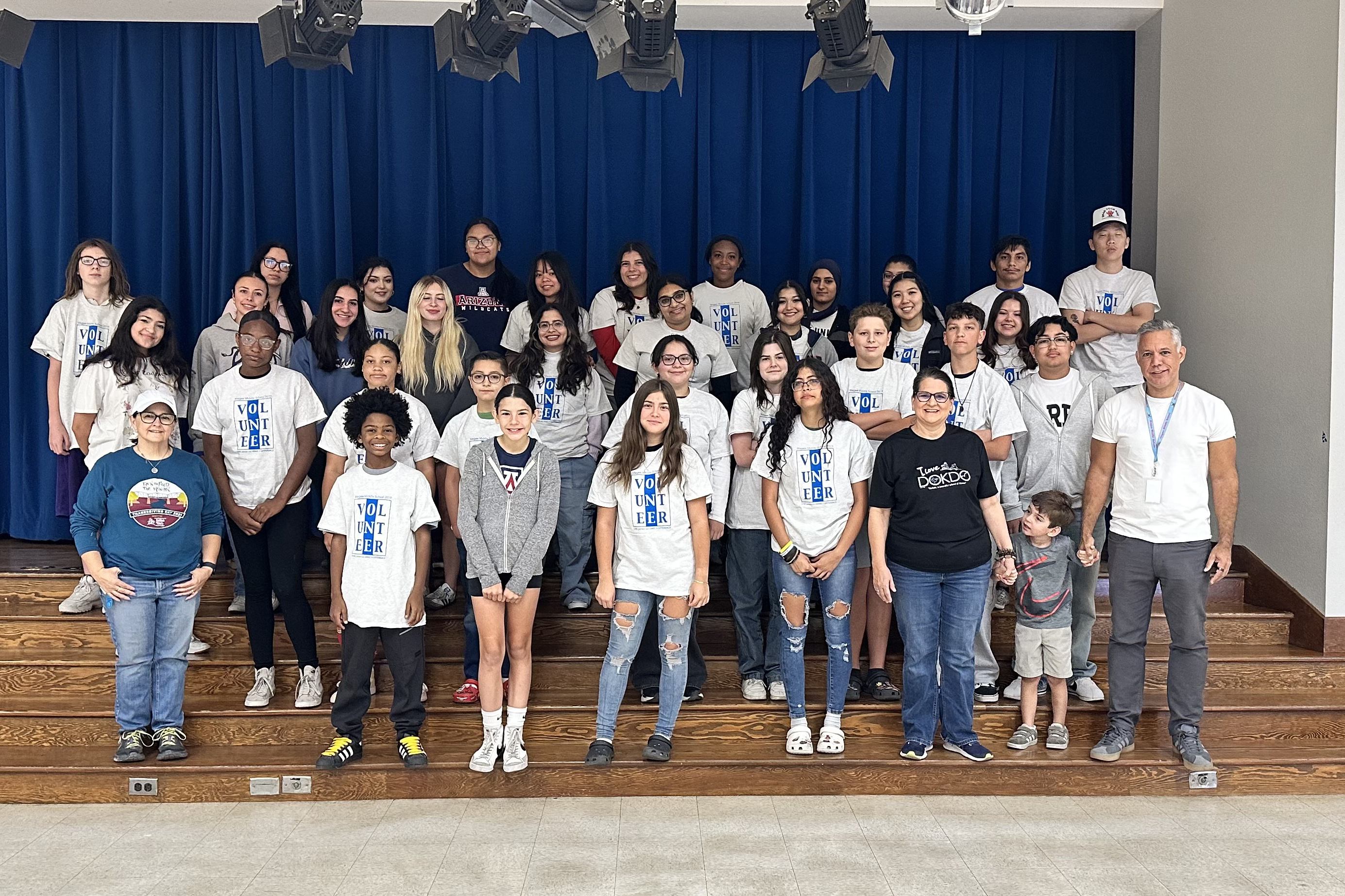 Students and staff pose in the auditorium