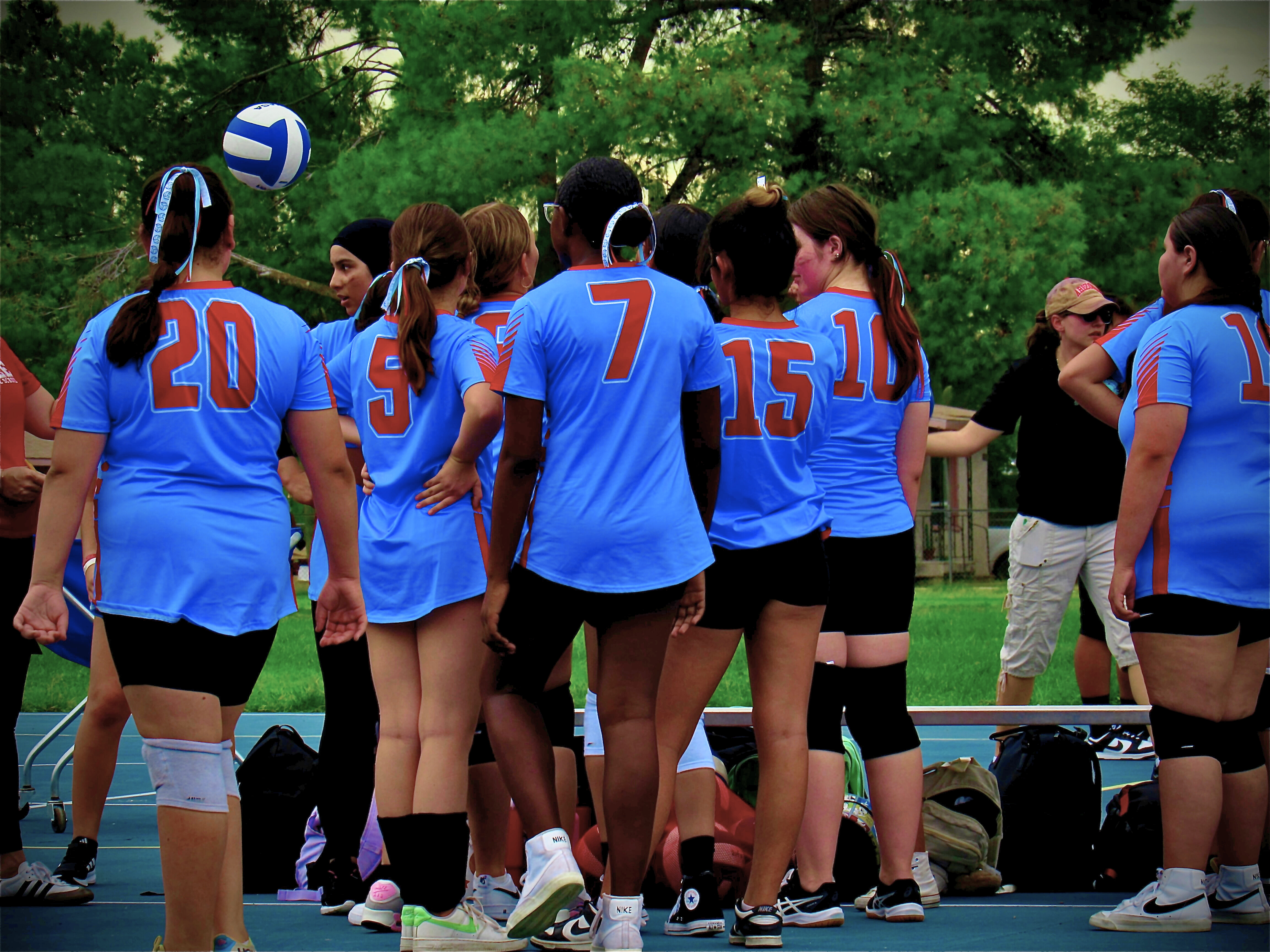 The Magee girls volleyball team huddles before a game