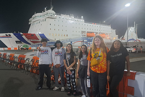 TKAP students in front of a cruise ship